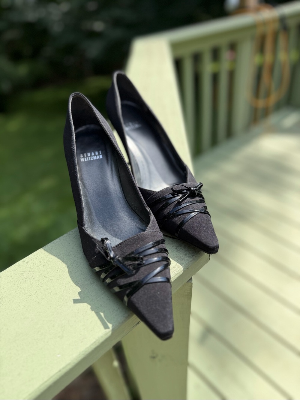 Classic black Stuart Weitzman pointy pumps with bow